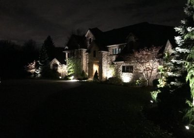 Ash project home exterior lit up in the evening