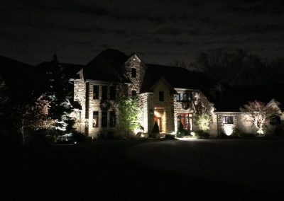 Ash project home exterior lit up in the evening