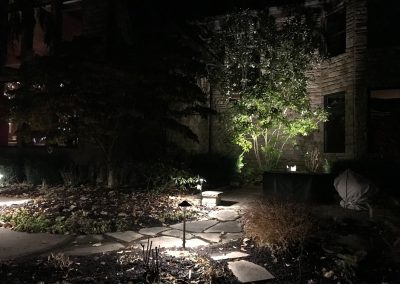 Ash project home exterior lit up in the evening