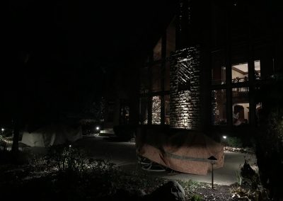 Ash project home exterior lit up in the evening