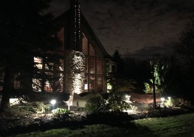 Ash project home exterior lit up in the evening